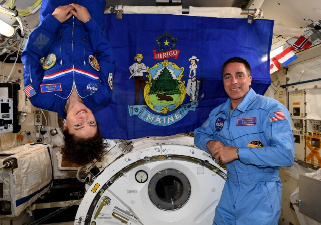 Astronauts Jessica Meir, Chris Cassidy, with Maine flag