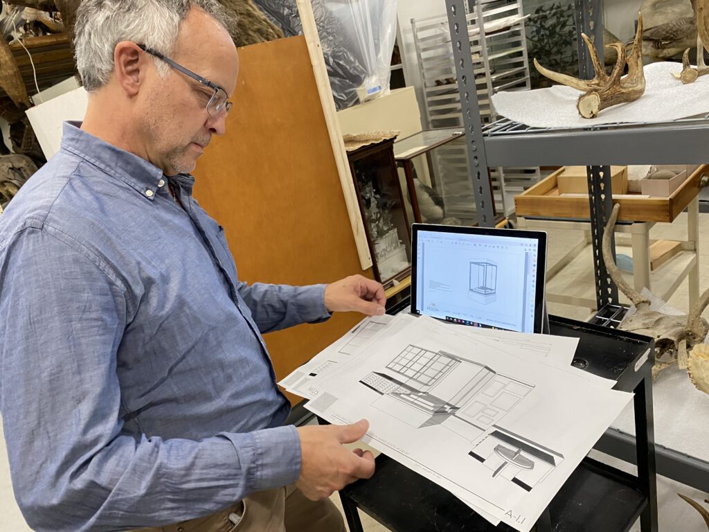 Museum staff reviewing exhibit plan