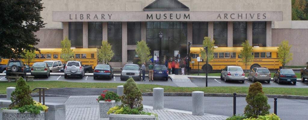 Exterior of Maine State Museum with busses and cards outside