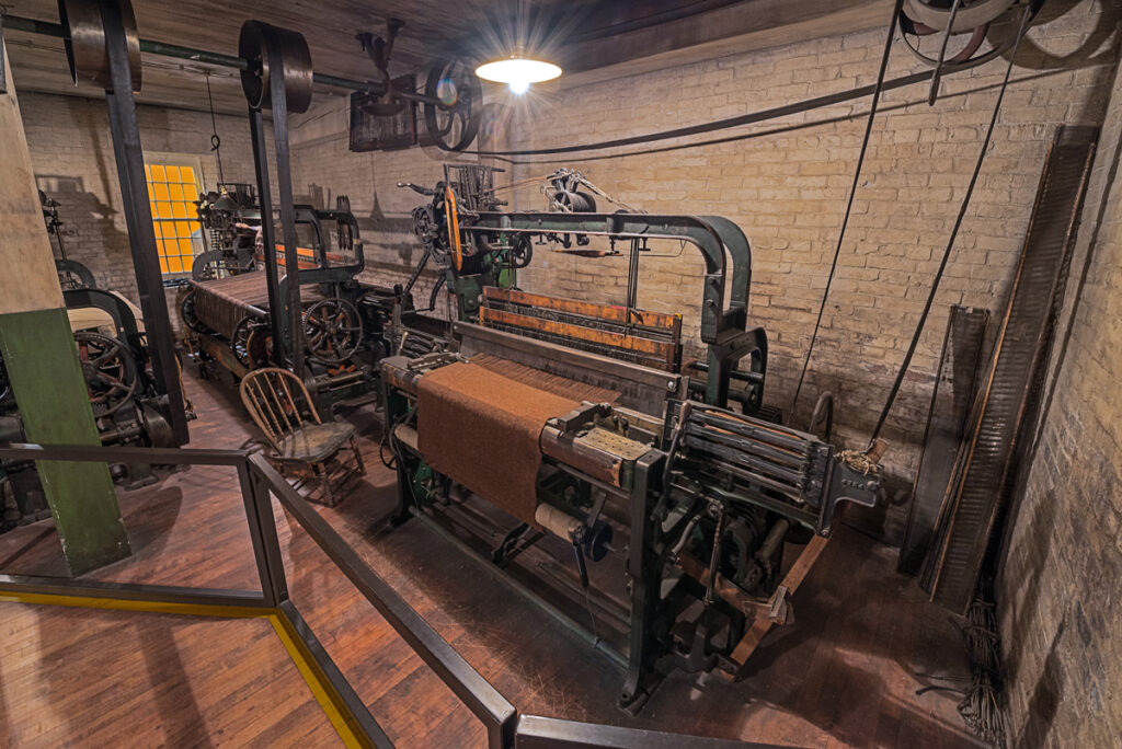 Large wool and weaving machines on display.