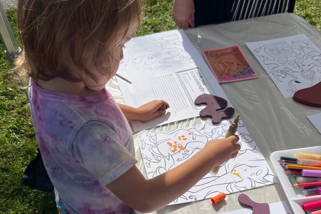 Child draws at a table.